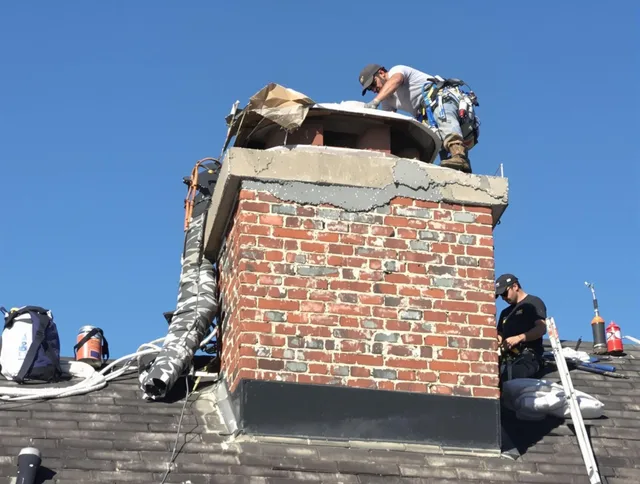 Lakewood Chimney Sweep installing a custom chimney crown in Lakewood, OH
