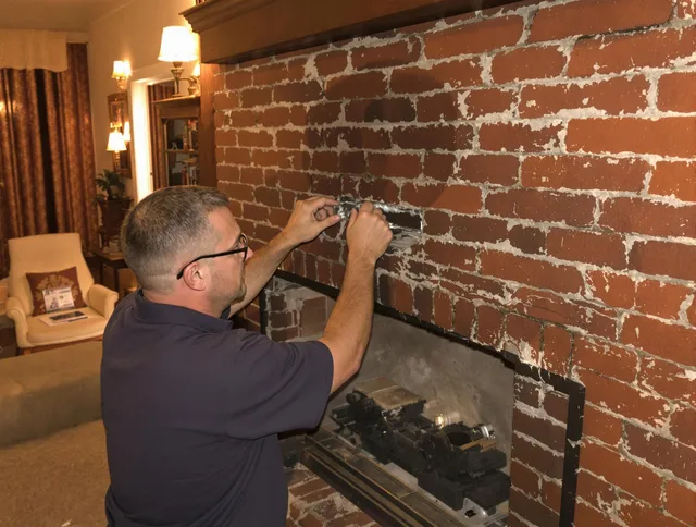 Lakewood Chimney Sweep expert fixing a fireplace in Lakewood, OH